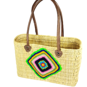 Straw basket decorated with a piece of colorful cotton